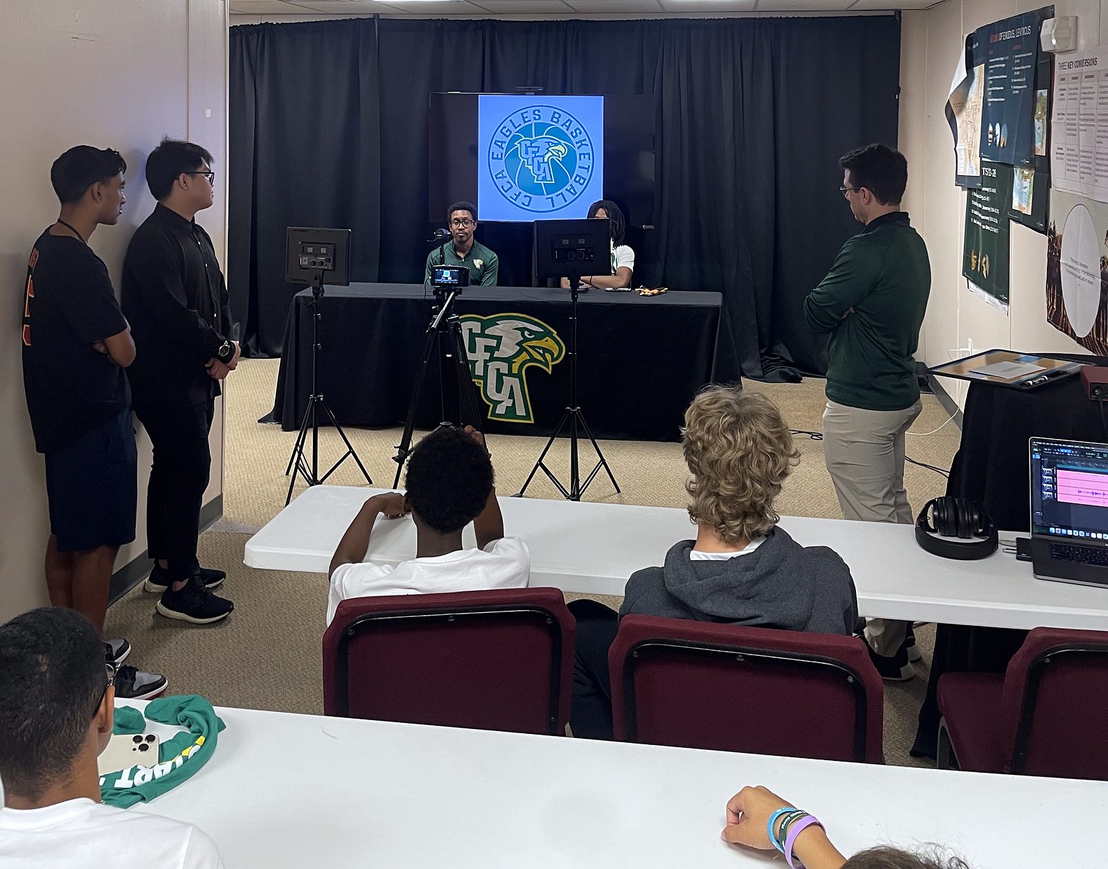 Students observing a CFCA postgame interview production setup.